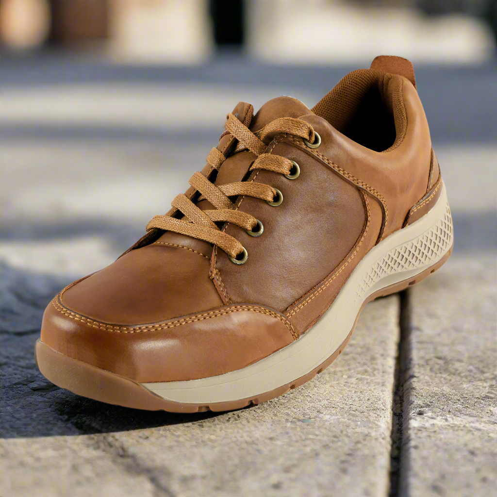 Brown leather sneaker on a concrete surface