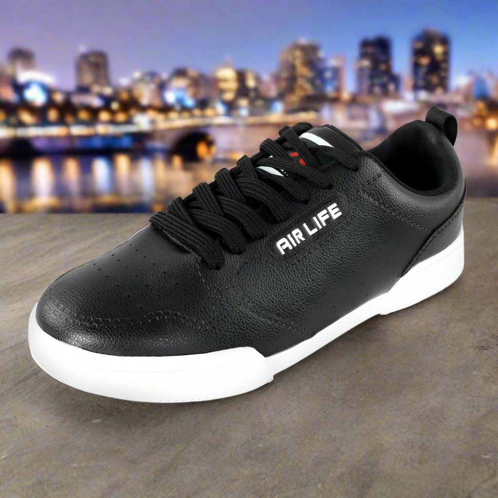 Black sneaker with 'AIR LIFE' branding on a stone surface with a cityscape background