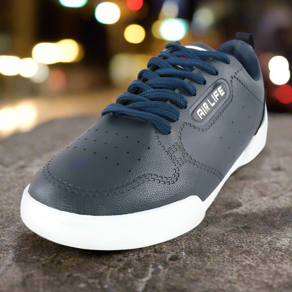 Gray sneaker with blue laces on a blurred street background
