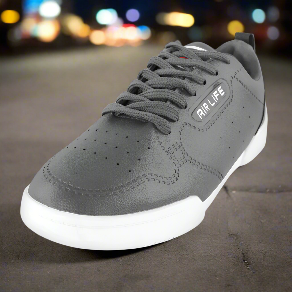 Gray sneaker with white sole on a blurred background