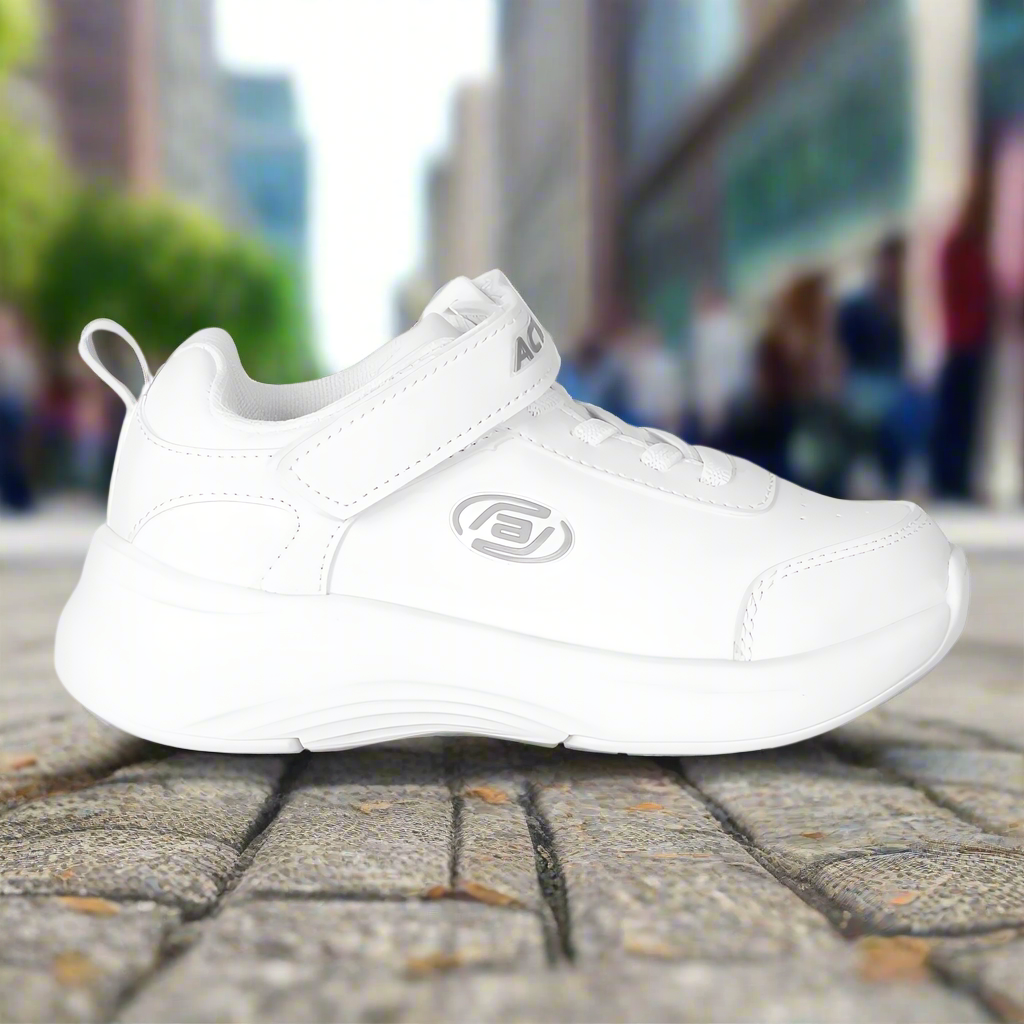 White athletic shoe on a city street with blurred background