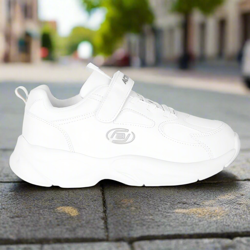White sneaker on a pavement with a blurred background
