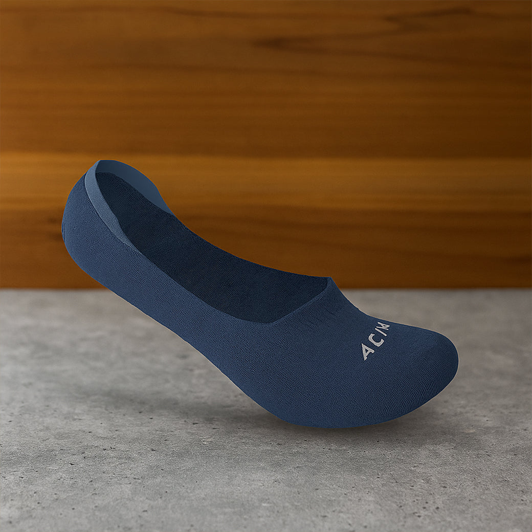 Blue shoe on a gray surface with a wooden background